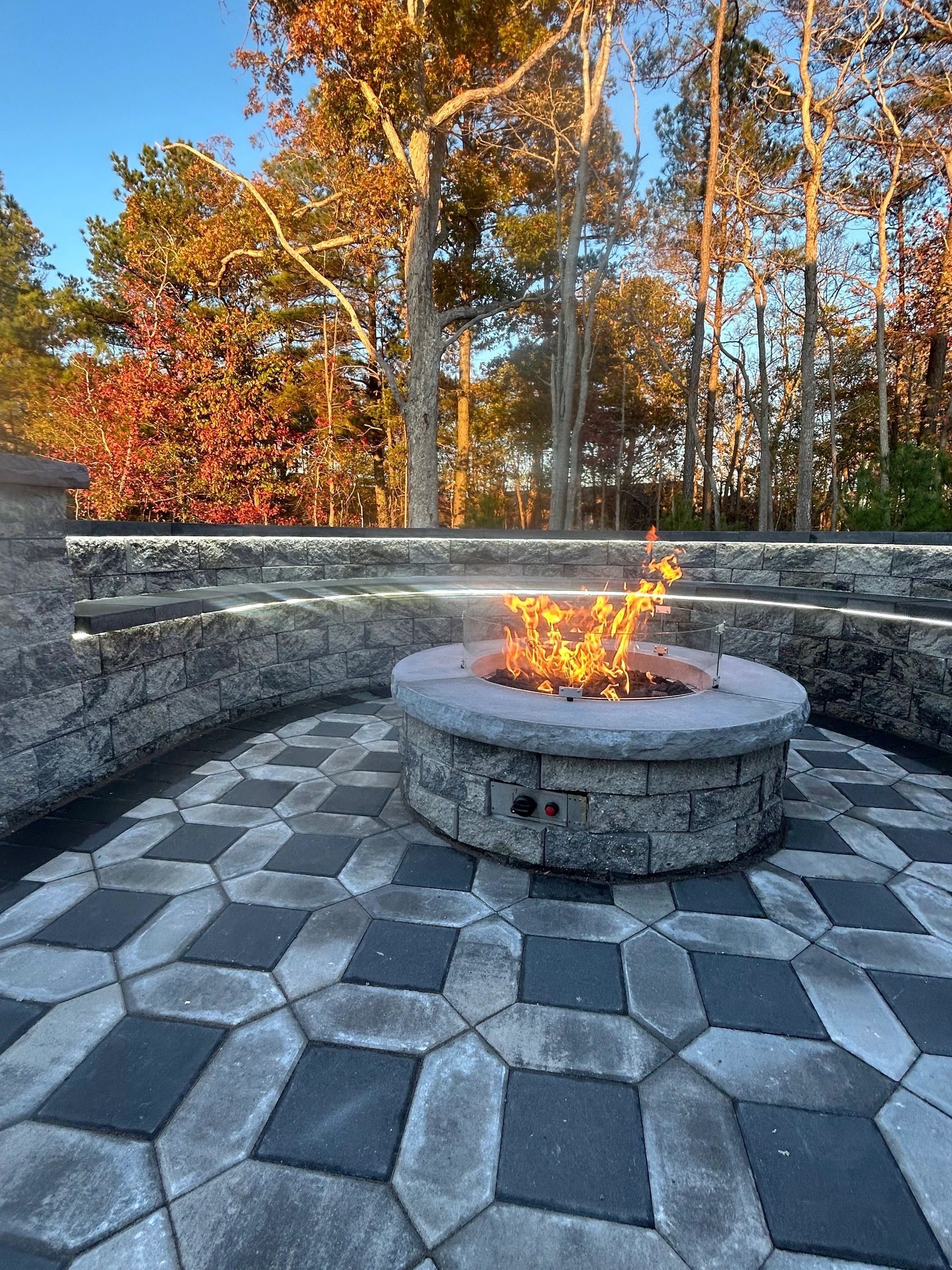 Fire pit stone patio with autumn landscaping